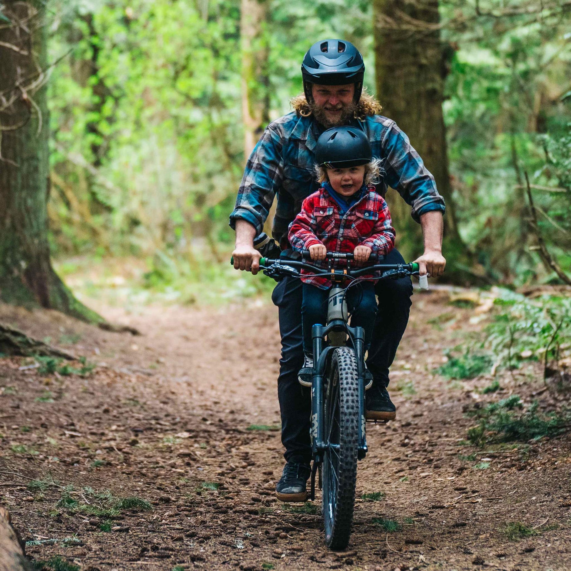 Shotgun Child Bike Handlebars Riding On Trail With Parent Close Up